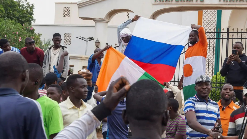 Stovky příznivců převratu se shromažďují a drží ruskou vlajku před Národním shromážděním v hlavním městě Niamey, Niger 27. července 2023
